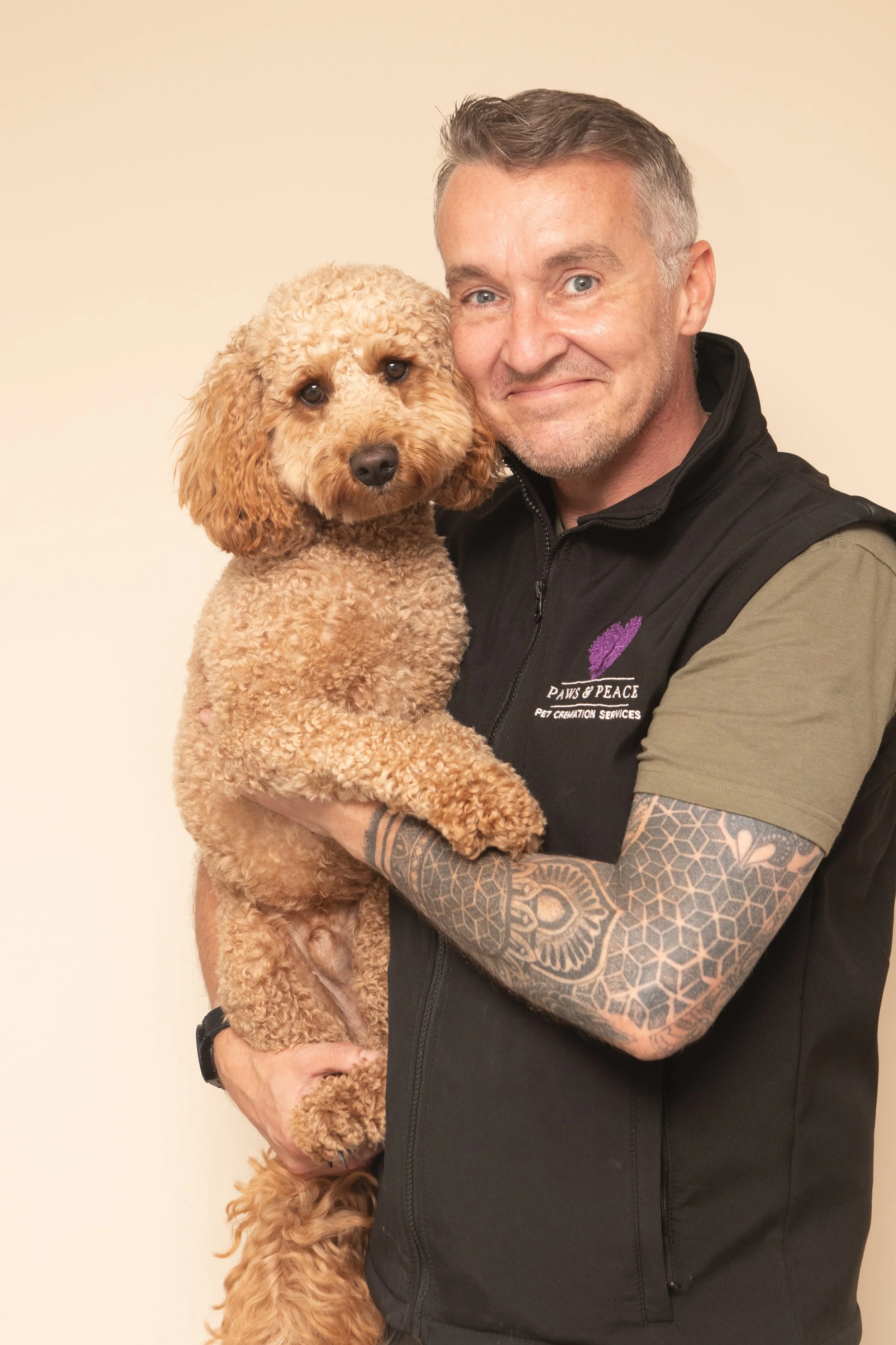 Alan, who runs Warrington Pet Farewells, holding his cockapoo